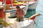 Fisherman mending nets, Poros, Greece.
