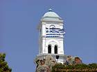Greek flag and bell tower, Poros, Greece.