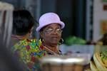 Merchant wearing a purple hat, Basse-Terre market, Guadeloupe.