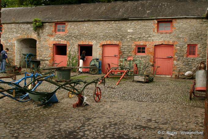 Farm tools exhibition in the courtyard, Bunratty Folk Park - Ireland