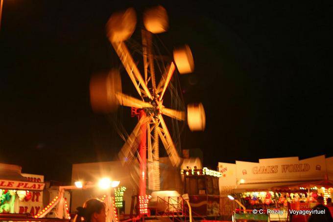 Festive carnival carousel seen at night, Dingle - Ireland