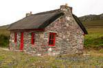 Stone house typical thatched roof, Achill Island, Ireland.