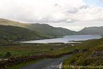 Lough and narrow road, Connemara, Ireland.