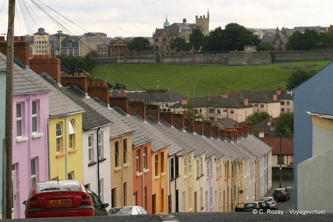 Steep street with colorful facades facing the ramparts, Derry - Nothern Ireland