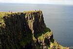 Walkers on the edge of the Antrim plateau, Giants Causeway, Nothern Ireland.