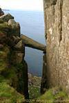 Balance broken column in the crack of the rock, Fairhead, Nothern Ireland.