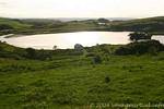 Lough na Cranagh filled with sunshine at the forefront of Fair Head, Nothern Ireland.