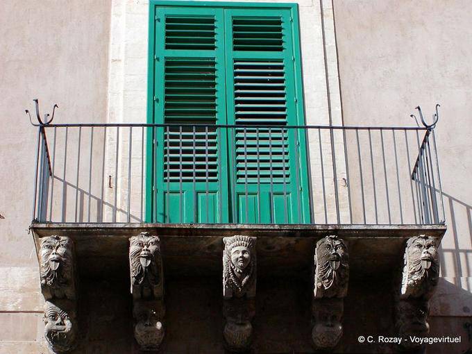 Balcony with carved heads, Noto - Italy