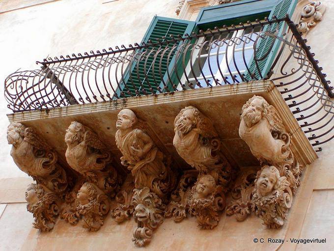Sculptures in the palace balcony Villadorata, Noto - Italy