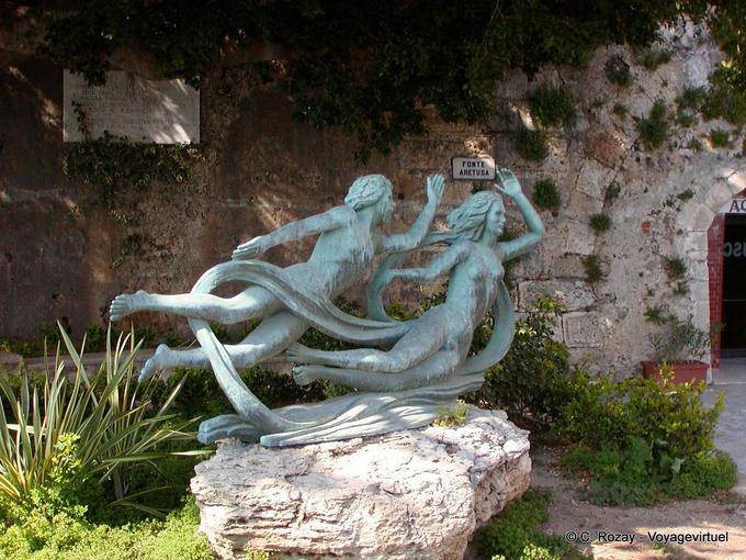 Statue in front of the Fountain of Arethusa, Ortigia, Syracuse, Sicily - Italy