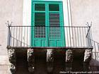 Balcony with carved heads, Noto, Italy.