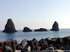 Nap in volcanic lava into chaos islands, Acci Trezza, Sicily, Italy.