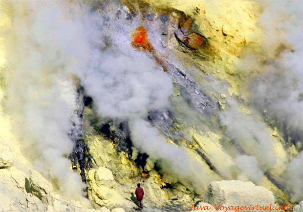 Ijen, hot sulfur ore is red leaving cracks, then drying it turns light yellow, Java - Indonesia