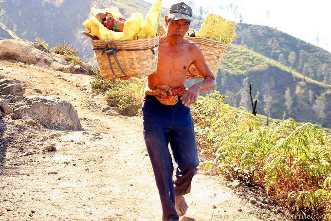 Kawah Ijen, sulfur carrier with bare feet - Indonesia