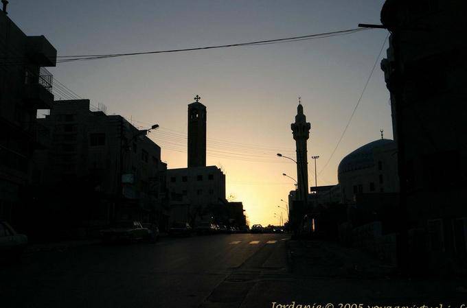 Tolerance: church tower and mosque minaret at sunset, Amman - Jordan