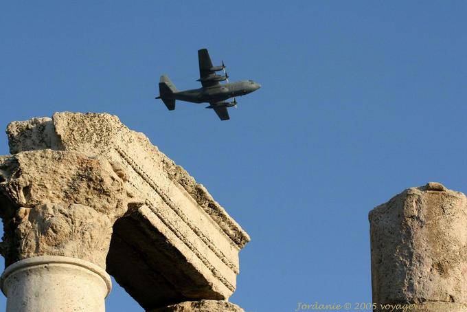 Propeller plane flying over the temple of Hercules, Amman - Jordan