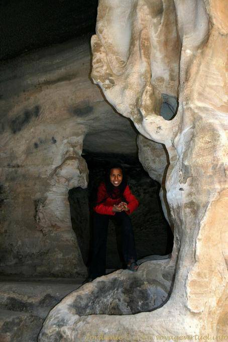 Smiling child in a cave dining room, equipped with a pool, Little Petra - Jordan