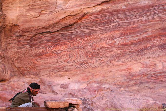 Man on rock climbing in Deir - Petra - Jordan