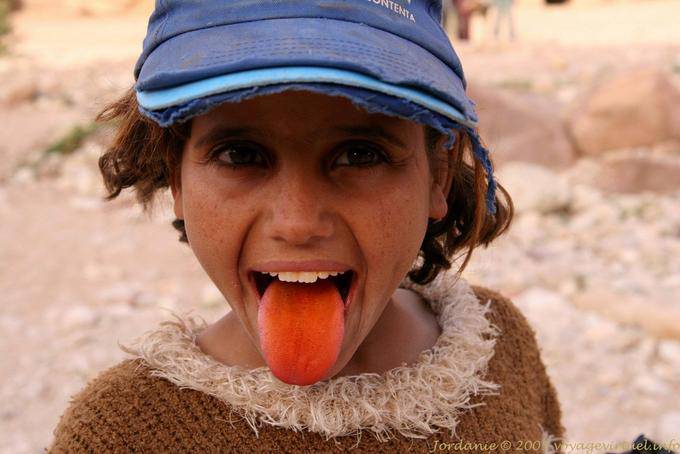 Girl pulling a red tongue, Petra Khubta - Jordan