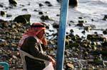 Jordan thoughtfully at the water's edge, Aqaba, Jordan.