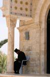 Orthodox priest reading in the shade, Qasr el Yehud, Jordan.