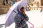 Jordan with an umbrella, southern theater, Jerash, Jordan.