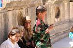 Spectator and kid in uniform, Southern theater, Jerash, Jordan.