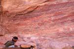 Man on rock climbing in Deir - Petra, Jordan.