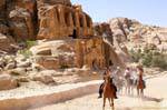 Cavaliers before the tomb with obelisks, al-Siq, Petra, Jordan.