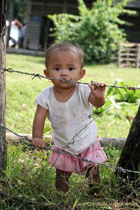 Child with barbed wire, Khone Island, Lao