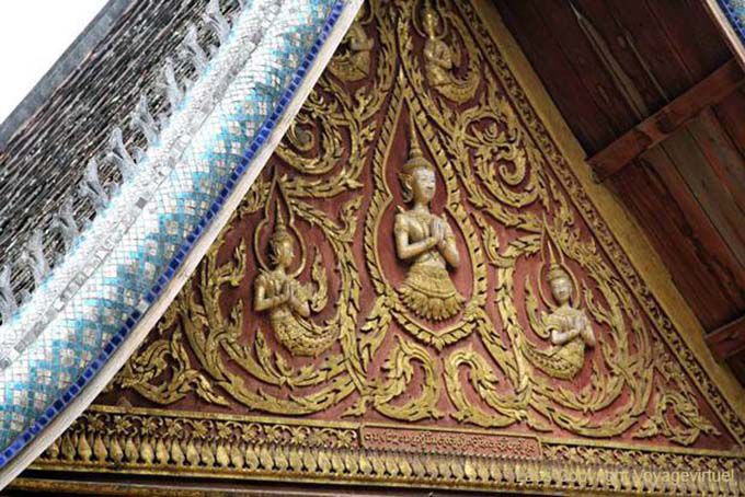 Pediment with vineyards and Buddhist figures, Wat Long Khun, Lao