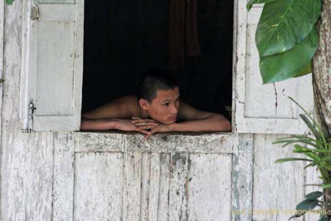 Monk thoughtfully at Kuti, Wat Visoun, Luang Prabang, Lao
