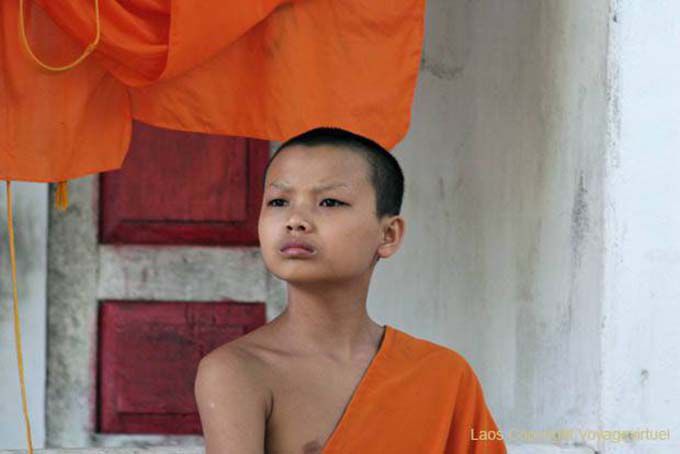Novice monk seriously in Kuti, Wat Visoun, Luang Prabang, Lao