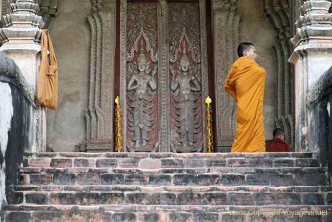 Monk on the steps of Haw Phra Kaew, Vientiane, Lao