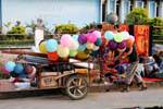 Charette seller of multicolored balloons, Luang Prabang, Lao.
