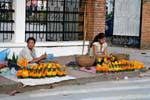 Making offerings on the sidewalk, Luang Prabang, Lao.