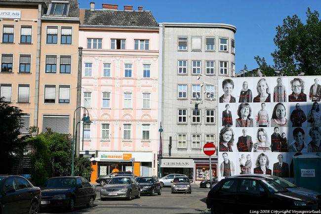 Schiller Platz, faces on a pub, Linz - Austria