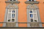 Pfarrgasse, orange facade and carved cherubs, Linz, Austria.