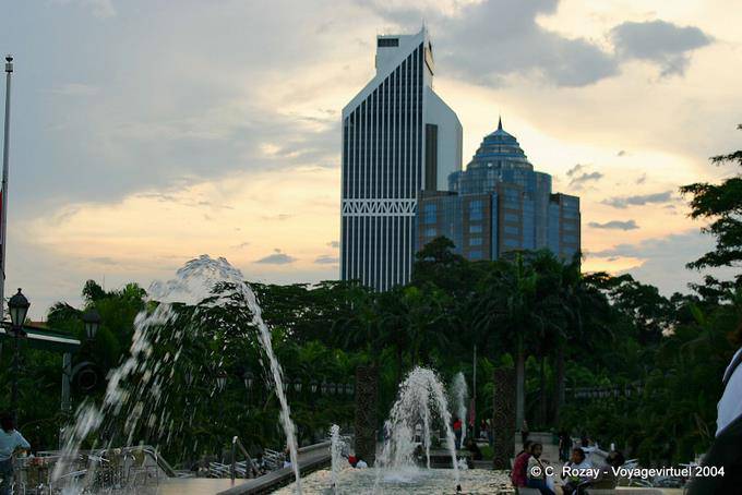 Sun and water jets before the Menara Olympia and Maybank, Kuala Lumpur - Malaysia