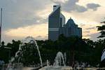 Sun and water jets before the Menara Olympia and Maybank, Kuala Lumpur, Malaysia.