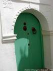 A green door with a hand of Fatma, Asilah, Morocco.