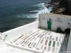 Decorating graves at the cemetery mausoleum Sidi Mansour Asilah, Morocco.