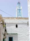 The blue and white minaret of a mosque in the Medina, Larache, Morocco.