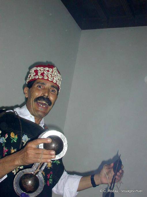 Hallucinatory light of Gnawa musician holding a qarqabus, Essaouira - Morocco