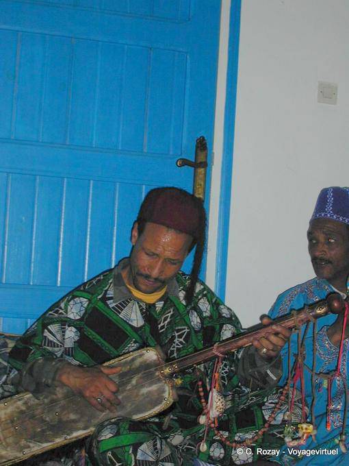 Gnaoua playing on a guembri instrument maâlem Dar Kenavo - Morocco