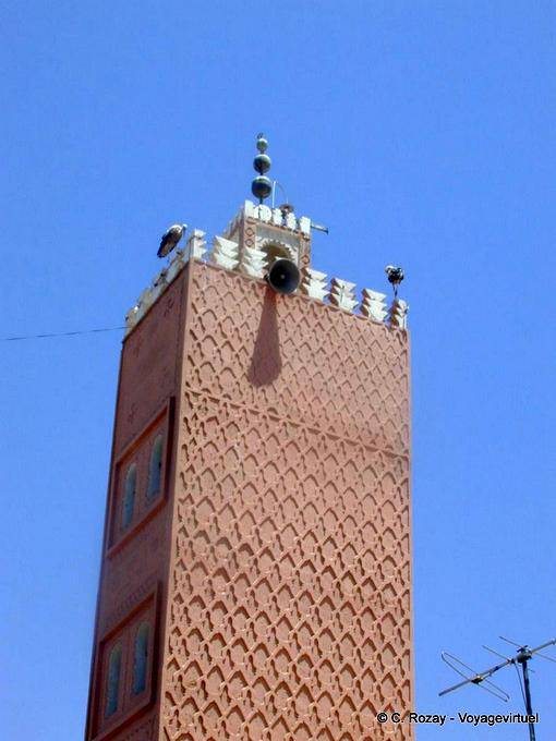 Storks perched on the minaret of the souk, Marrakech - Morocco