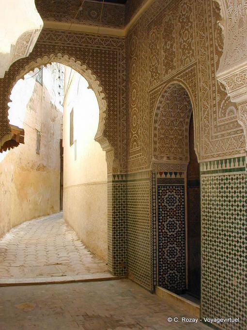 Stucco ornamentation and Moroccan tiles in an alley in Meknes - Morocco
