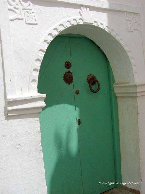 A green door with a hand of Fatma, Asilah - Morocco