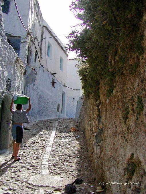 Cobbled street cobbles and child wearing the clothes on his head, Chefchaouen - Morocco
