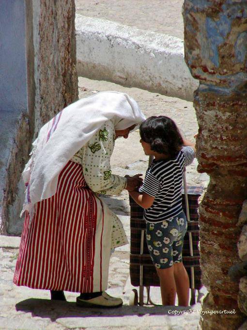 The old woman in traditional dress and the little girl, Chefchaouen - Morocco